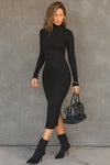 Full body front view of model posing in the fitted black rib Mock Neck Midi Dress with a mock turtleneck neckline, long sleeves and a mid-calf length