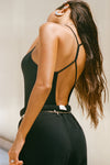 Back view of model posing in the full length black modal Open T-Back Cami