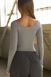 Back view of model posing in the fitted, light weight shadow modal Boatneck Long Sleeve with boat neckline and scoop back