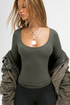 Front view of model posing in the fitted and stretchy mineral rib Classic Scoop Long Sleeve with a scoop neckline