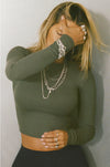 Front view of model posing in the fitted cropped mineral rib Cropped Crew Long Sleeve top with a crew neckline