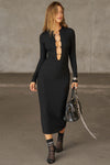 Full body front view of model posing in the fitted black flexrib Clasp Midi Dress with long sleeves, a crew neckline and front cutouts cinched together with metal clasp embellishments