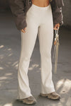 Front view of model from the waist down posing in the mid-rise fitted natural luxe knit Fitted Mini Flare Pant with a slightly flared leg