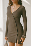 Front view of model posing in the soft and fitted army luxe knit Asymmetrical Button Mini Dress with long sleeves,  a v-neckline and asymmetrical button-front details. 