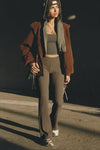 Full body front view of model posing in the mid-rise fitted army luxe knit Fitted Mini Flare Pant with a slightly flared leg