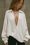 Front view of model posing in the oversized natural luxe knit Deep V Pullover with a plunging collared neckline and dropped shoulders