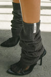 Close up side view of the slouchy, pull on ink luxe knit Leg Warmers that can be worn pulled up on scrunched down