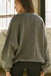 Back view of model posing in the relaxed fit washed sage french terry Oversized Crew Pullover sweatshirt with dropped sleeves and a ribbed crew neckline