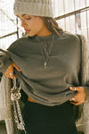 Front view of model posing in the relaxed fit washed sage french terry Oversized Crew Pullover sweatshirt with dropped sleeves and a ribbed crew neckline