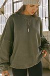 Front view of model posing in the relaxed fit washed sage french terry Oversized Crew Pullover sweatshirt with dropped sleeves and a ribbed crew neckline