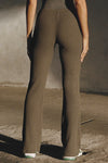 Back view of model from the waist down posing in the mid-rise fitted army luxe knit Fitted Mini Flare Pant with a slightly flared leg