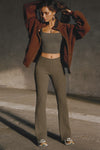 Full body front view of model posing in the mid-rise fitted army luxe knit Fitted Mini Flare Pant with a slightly flared leg