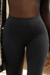 Close up detail front view of model from the waist down wearing the sleek and stretchy full length sueded onyx The Body Legging with a mid-rise elastic waistband