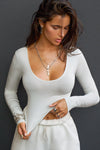 Front view of model wearing the fitted soft chalk modal Scoop Neck Long Sleeve top with a deep scoop neckline and fitted sleeves