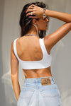 Back view of model posing in the fitted sueded white Scoop Neck Smoothing Bra top with a scoop back and Joah Brown logo patch that can be worn in the front or the back