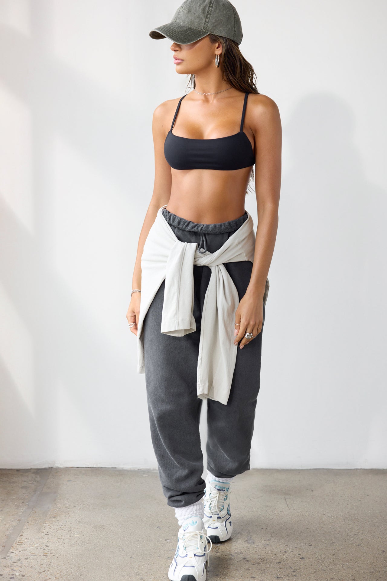 Full body front view of model posing in the oversized loose fit washed black french terry Oversized Jogger with an elastic waistband and ankle cuffs