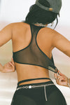 Back view of model posing in the the black mesh scoop neck racerback bra