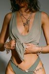 Close up front view of model posing in the lightweight relaxed fit sage modal Plunge Tank with a plunging u-neckline