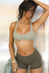 Front view of model posing in the fitted, soft army luxe knit Foldover Short with a foldover waist band that can be worn high, low or mid-rise