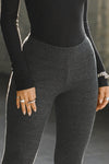 Close up front view of model from the waist down posing in the mid-rise fitted ink luxe knit Fitted Mini Flare Pant with a slightly flared leg