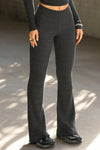 Front view of model from the waist down posing in the mid-rise fitted ink luxe knit Fitted Mini Flare Pant with a slightly flared leg