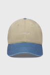 Flat lay front view of the six-panel khaki with vintage blue brim Official Cap with a curved brim and an embroidered upside down Joah Brown logo on the front