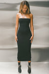 Full body front view of model posing in the fitted black model Foldover Maxi Skirt with an adjustable fold over waistband, wearing it as a tube dress