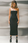 Full body front view of model posing in the fitted black model Foldover Maxi Skirt with an adjustable fold over waistband, wearing it as a tube dress