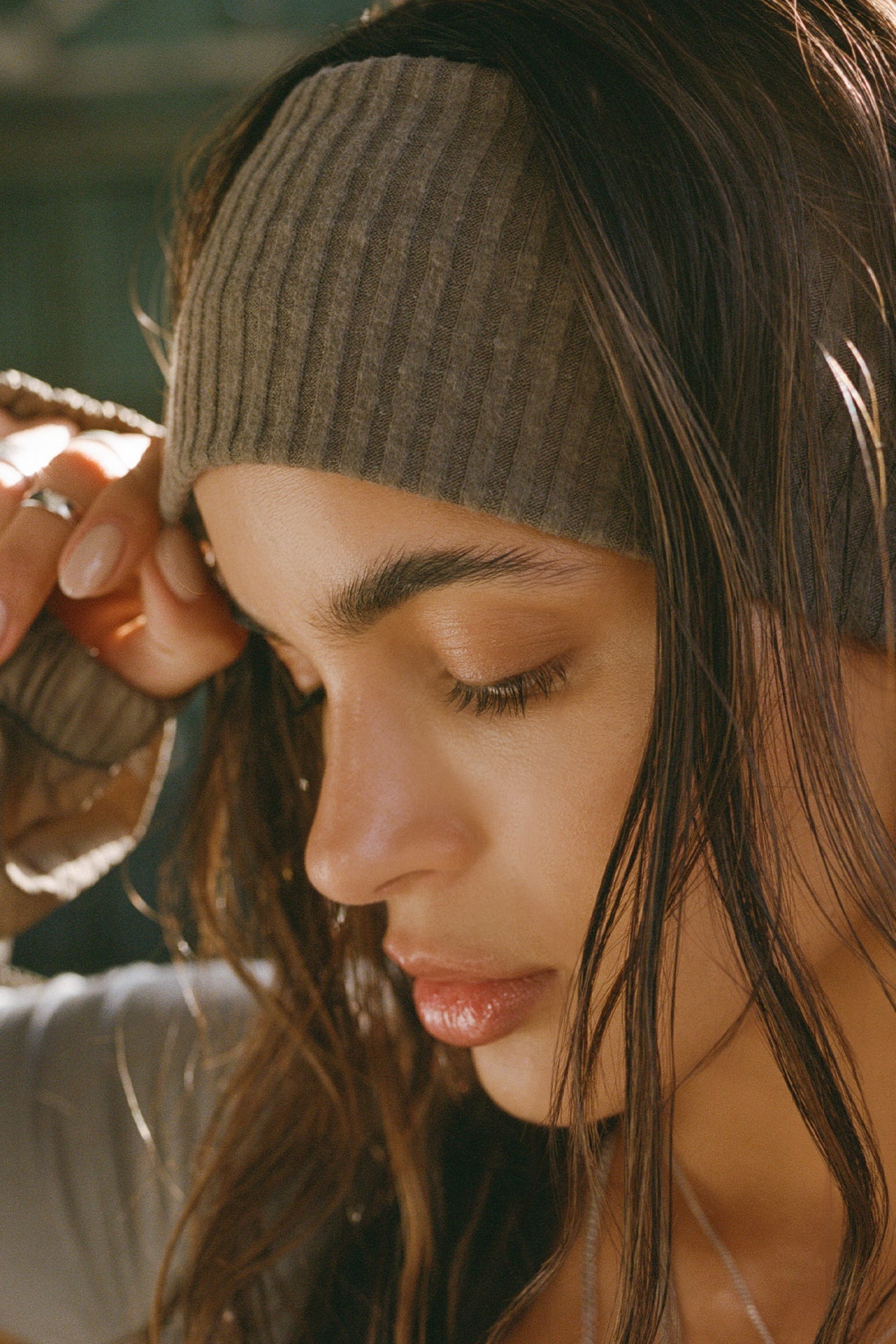 Close up side view of model posing cozy and soft wide army luxe knit Knit Headband that covers the ears for warmth