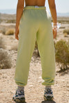 Back view of model from the waist down wearing the oversized loose fit melon french terry Oversized Jogger with an elastic waistband and ankle cuffs