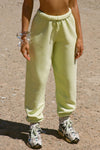Front view of model from the waist down wearing the oversized loose fit melon french terry Oversized Jogger with an elastic waistband and ankle cuffs