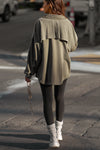 Full body back view of model walking in the street wearing the relaxed fit fern sherpa Oversized Button Down shirt jacket with a classic collar, front button closures and contrasting fabric details.