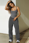 Full body front view of model posing in the fitted and stretchy smoke flexrib Low Back Scoop Tank with a u-neckline, thin straps and a  low scoop back.