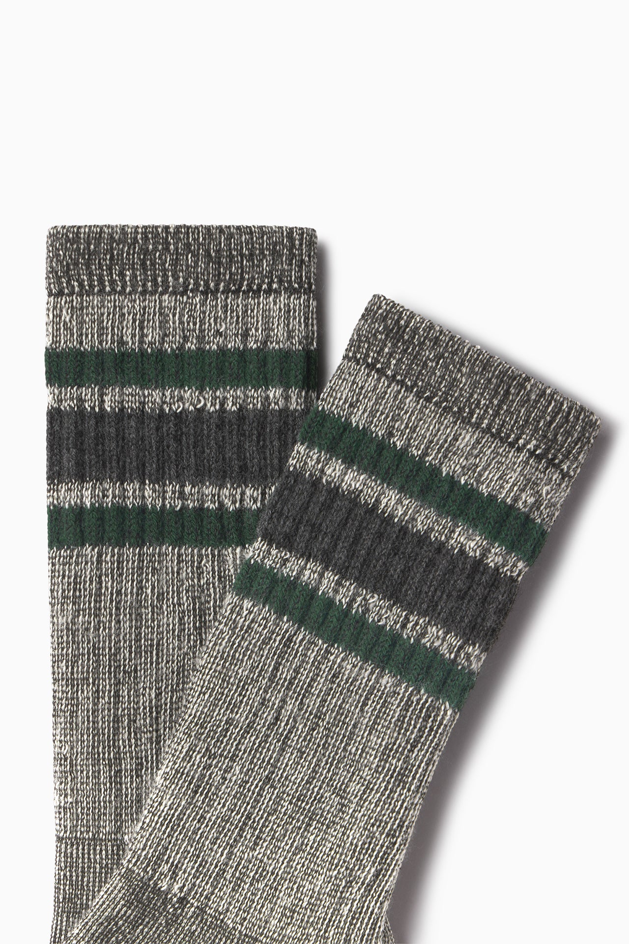 Close up flat lay side view of the crew-style ribbed and soft heathered charcoal Merino Stripe Sock