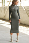 Full body front view of model posing in the fitted mineral rib Mock Neck Midi Dress with a mock turtleneck neckline, long sleeves and a mid-calf length