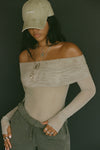 Front view of model posing in the fitted dew mesh Off The Shoulder Long Sleeve top with a folded off-the-shoulder neckline and thumbholes in the sleeves