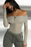 Front view of model posing in the fitted dew mesh Off The Shoulder Long Sleeve top with a folded off-the-shoulder neckline and thumbholes in the sleeves