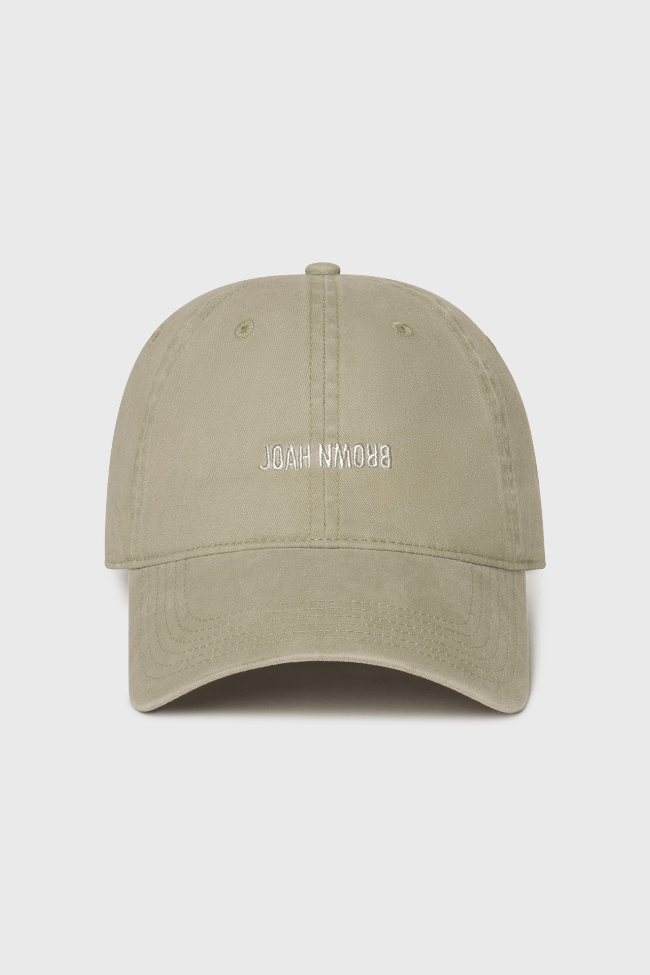 Flat lay front view of the six-panel desert Official Cap with a curved brim and an embroidered upside down Joah Brown logo on the front