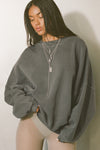 Front view of model posing in the relaxed fit washed sage french terry Oversized Crew Pullover sweatshirt with dropped sleeves and a ribbed crew neckline