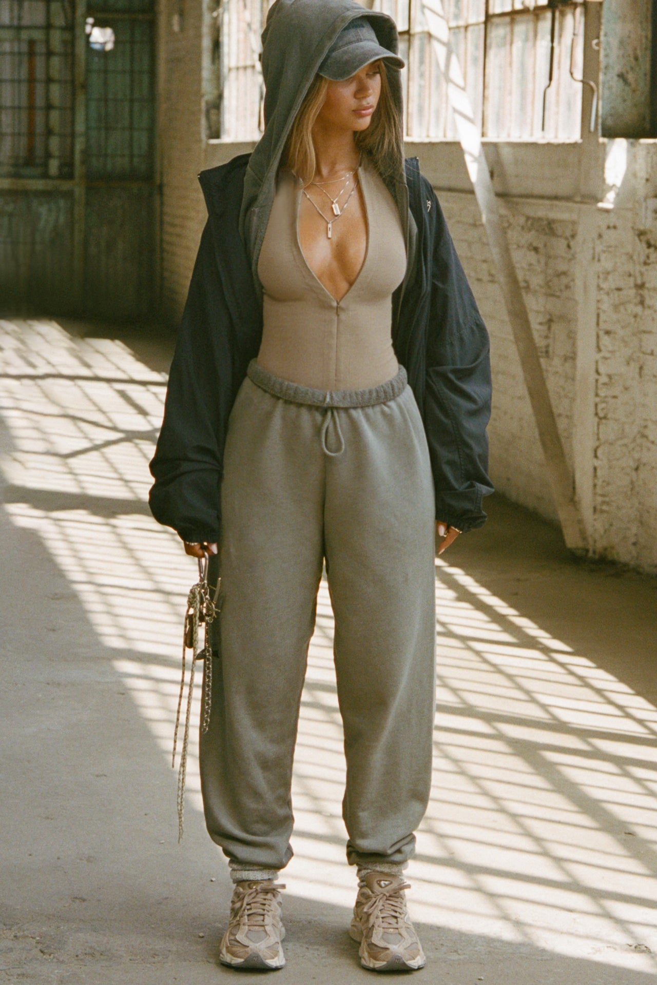 Full body front view of model posing in the oversized loose fit vetiver french terry Oversized Jogger with an elastic waistband and ankle cuffs