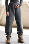 Front view of model from the waist down wearing the oversized loose fit washed black french terry Oversized Jogger with an elastic waistband and ankle cuffs