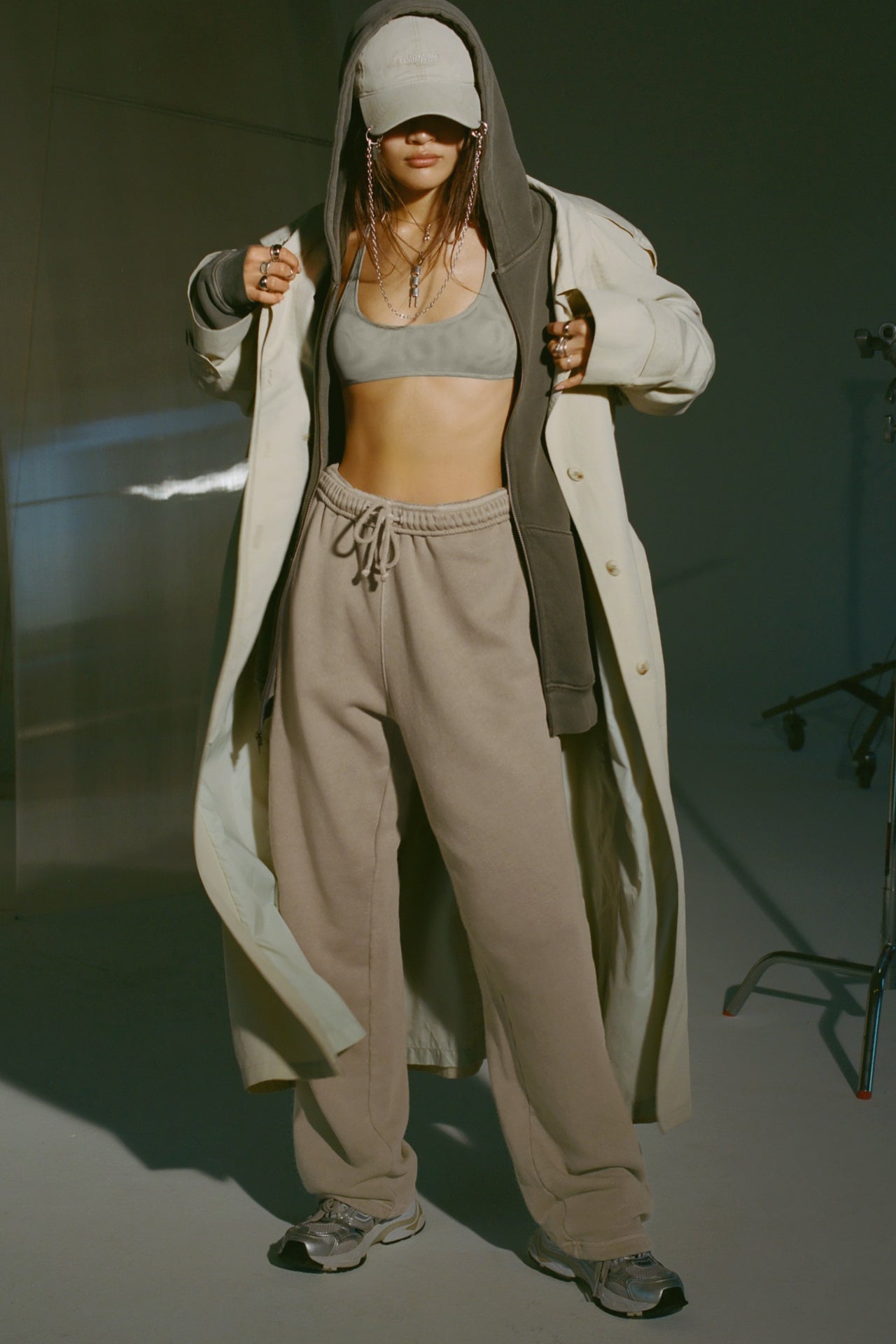 Full body front of model posing in the relaxed fit sand french terry Oversized Straight Leg Jogger with an elastic waistband, hidden drawstring, pocket details. and adjustable cinching at the ankle cuffs