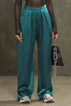 Front view of model from the waist down posing in the soft and smooth classic pleated lagoon silk Relaxed Silk Trouser with a flattering wide leg, zip fly and side pockets.