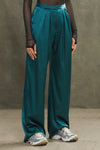 Front view of model from the waist down posing in the soft and smooth classic pleated lagoon silk Relaxed Silk Trouser with a flattering wide leg, zip fly and side pockets.