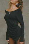 Side view of model posing in soft and lightweight black modal Ruched Asymmetrical Long Sleeve top with fitted sleeves, a relaxed asymmetrical hemline and a flattering ruched side detail.