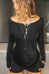 Front view of model posing in soft and lightweight black modal Ruched Asymmetrical Long Sleeve top with fitted sleeves, a relaxed asymmetrical hemline and a flattering ruched side detail.