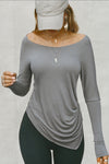 Front view of model posing in soft and lightweight shadow modal Ruched Asymmetrical Long Sleeve top with fitted sleeves, a relaxed asymmetrical hemline and a flattering ruched side detail.