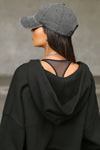 Back view of model posing in the sheer black mesh Scoop Neck Racerback Bra with a raceback silhouette