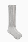 Flat lay side view of the slouchy salt Scrunch Sock with extra long ribbed cuffs