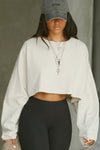 Front view of model posing in the cropped relaxed fit fog cotton slouchy crop long sleeve top with a crew neckline, dropped shoulders and oversized sleeves